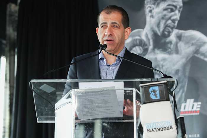 Espinoza speaks from a lectern.